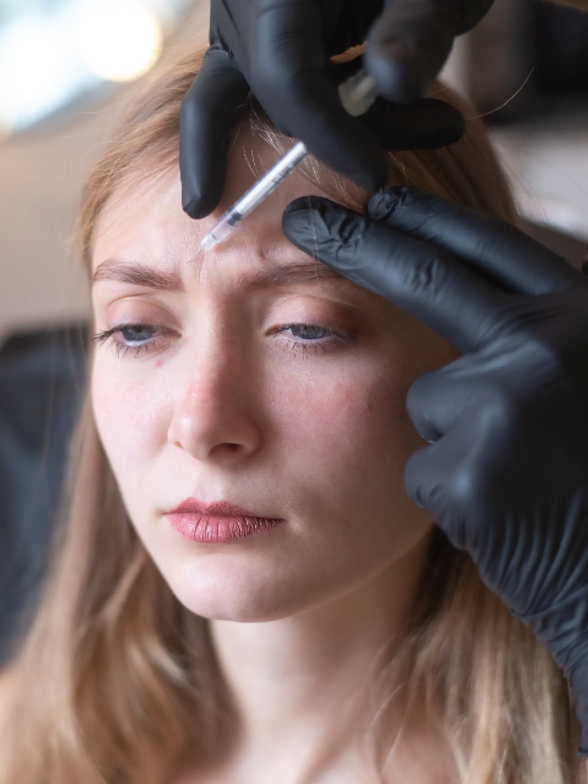 a woman getting her eyebrows injection