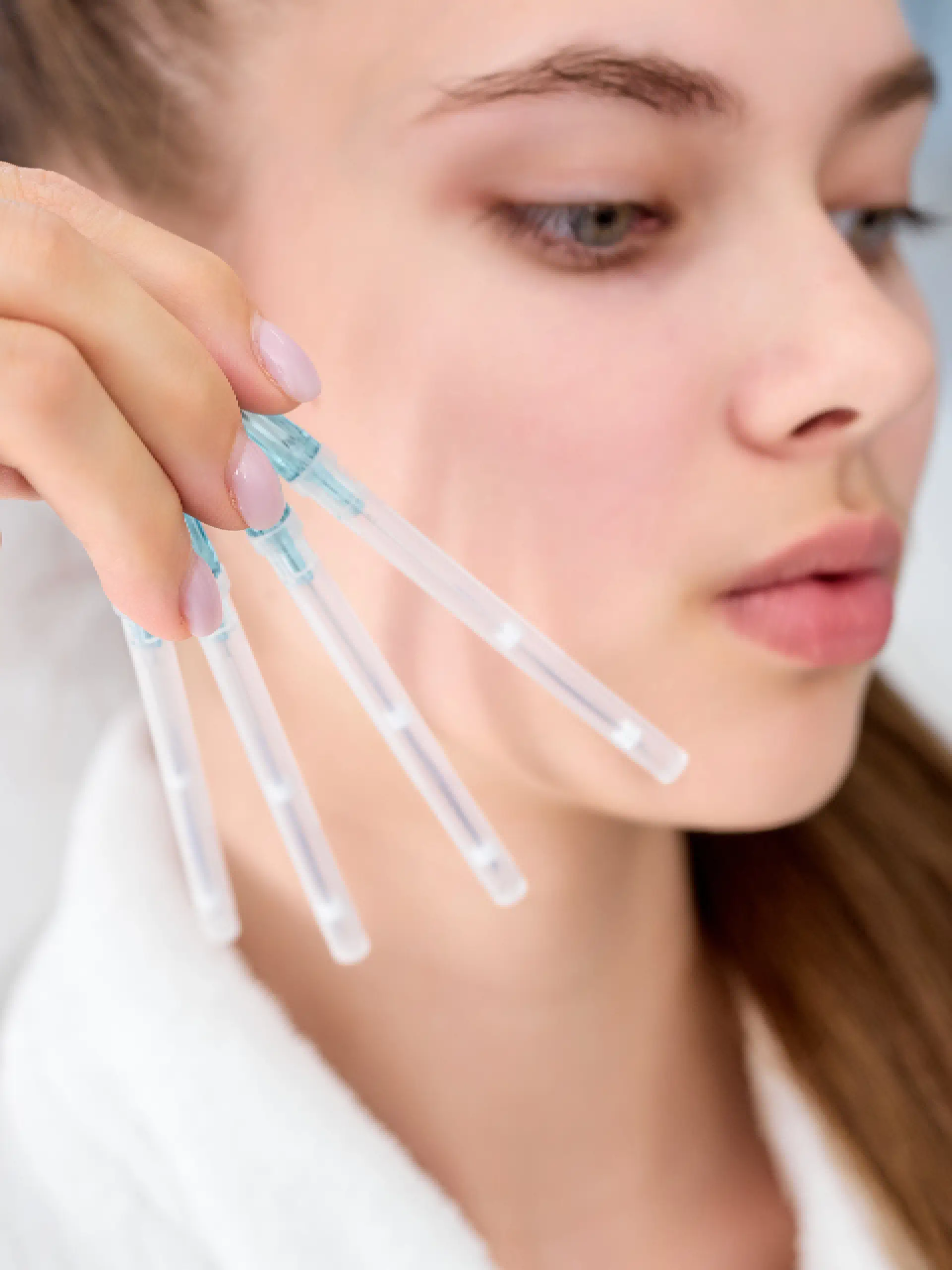 a woman holding a few plastic tubes