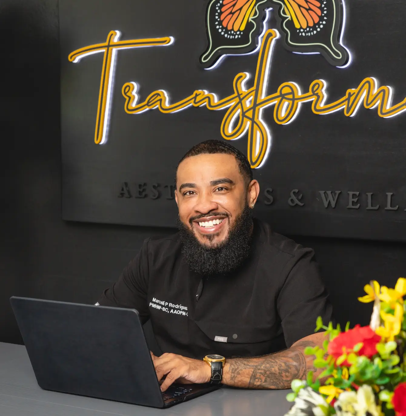 a man sitting at a table with a laptop